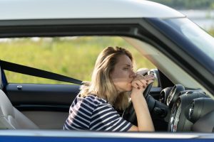 Anxious upset woman in car. Female driver look on road suffer from anxiety headache scared to drive