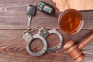gavel-key-handcuffs-whiskey-top-view-2024-09-15-15-46-21-utc-min