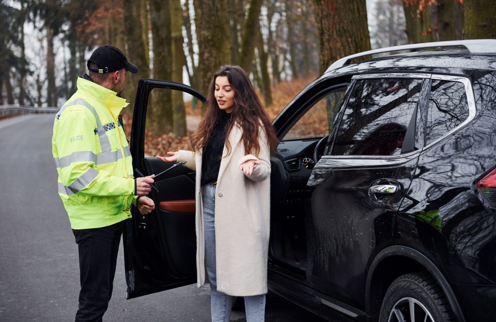 male-police-officer-in-green-uniform-talking-with-woman