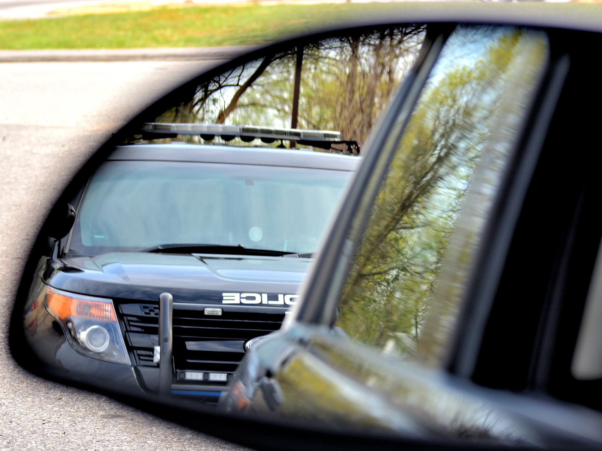 police officer seen in side view mirror