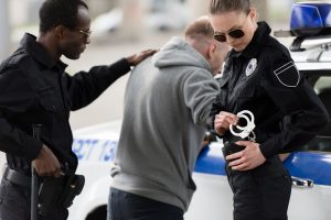 police-officers-arresting-male-bandit-near-car-2024-11-18-07-15-53-utc