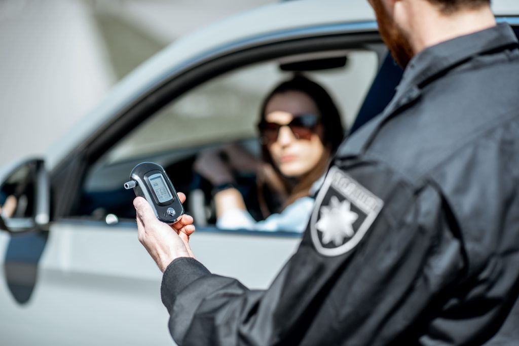 policeman-with-alcotest-device-2023-11-27-05-23-35-utc