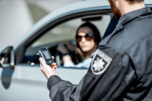 policeman-with-alcotest-device-2023-11-27-05-23-35-utc