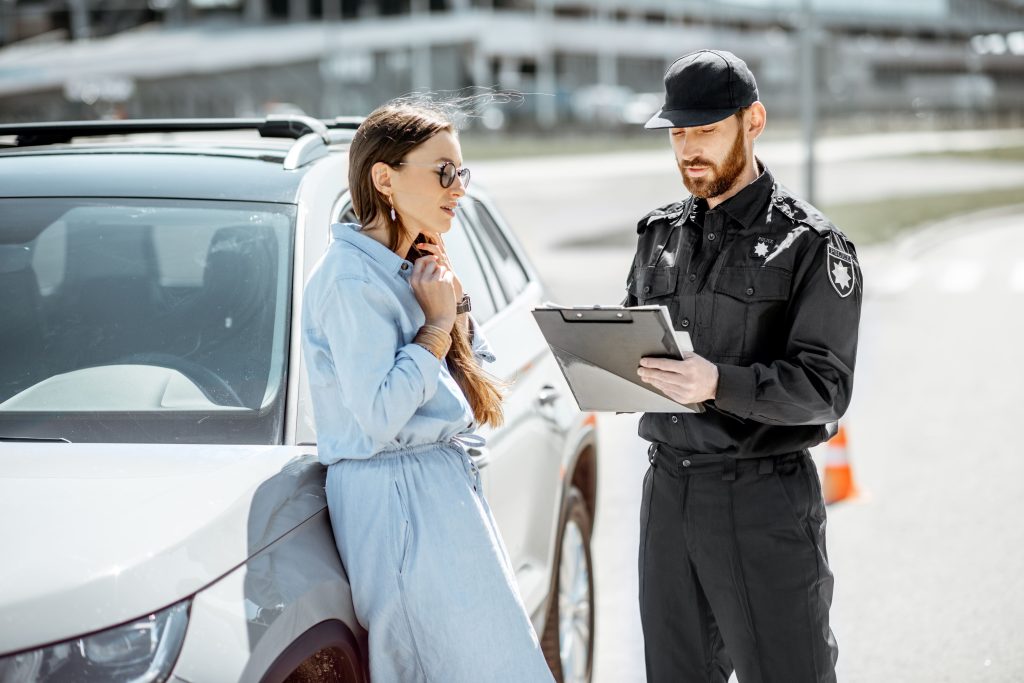 policeman-with-female-driver-on-the-roadside-2023-11-27-05-33-36-utc