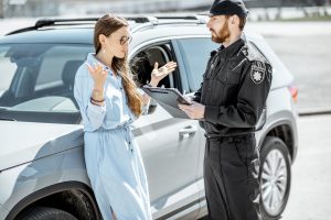 policeman-with-female-driver-on-the-roadside-2023-11-27-05-36-39-utc