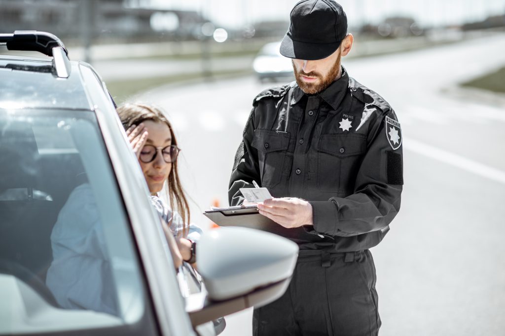 Policeman with woman driver on the road