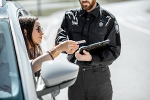 Policeman with woman driver on the road