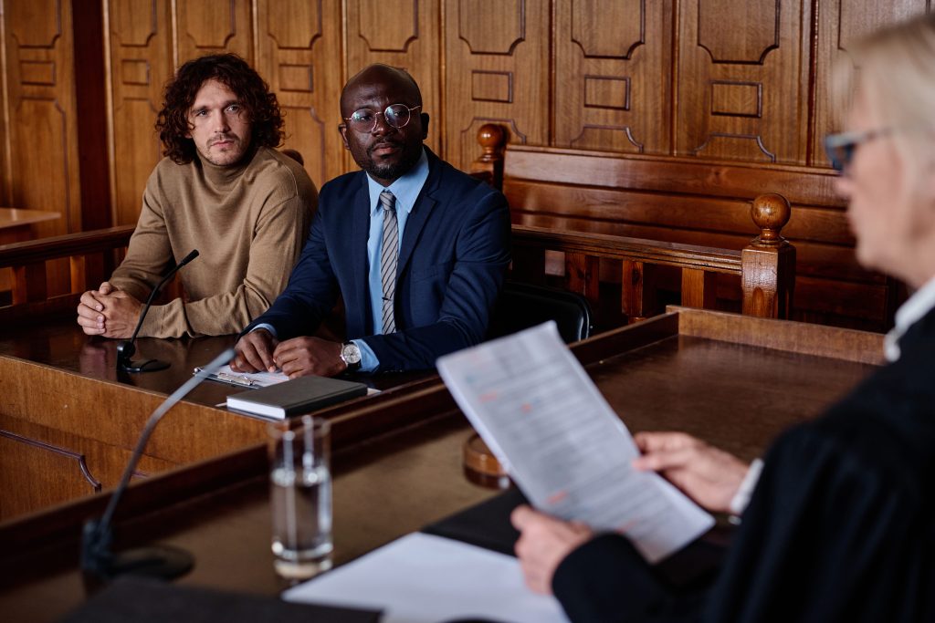 two-young-intercultural-male-attorneys-looking-at-2023-11-27-05-03-41-utc