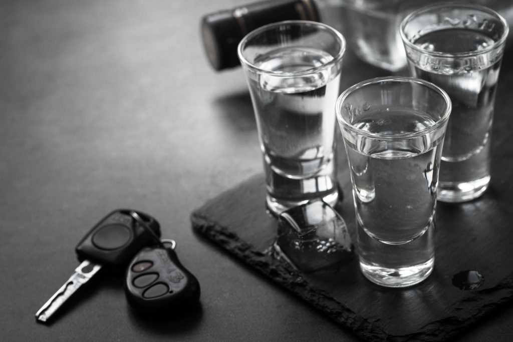 Vodka shot drink and car key.
