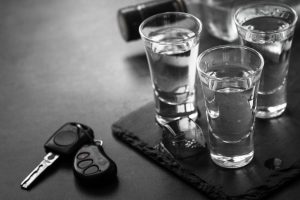 Vodka shot drink and car key.