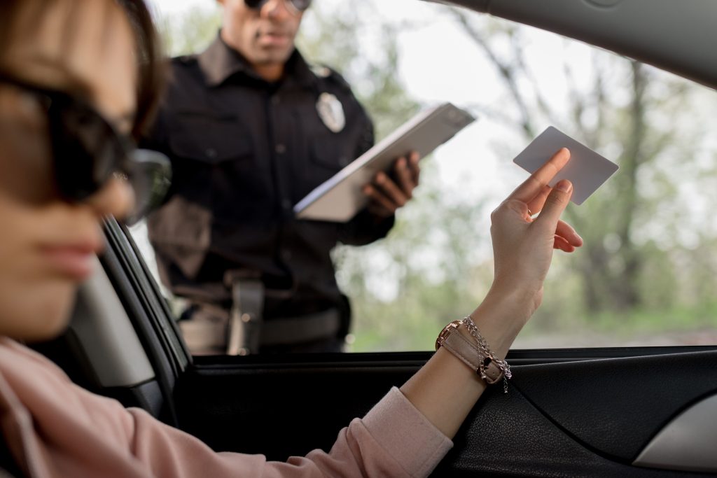 woman-in-sunglasses-sitting-in-car-and-giving-driv-2024-11-19-14-48-20-utc